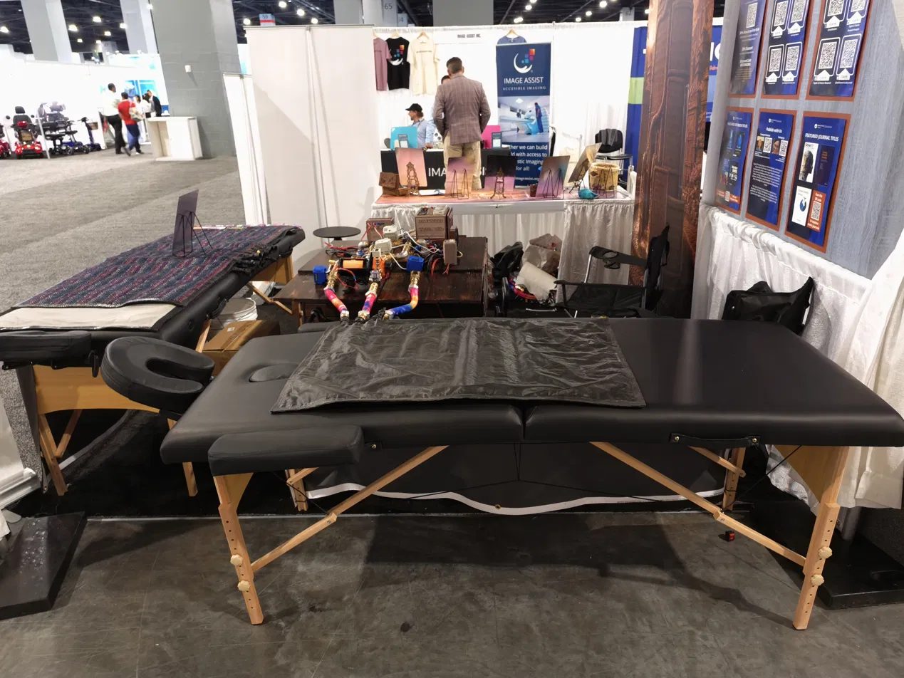Drycuzzi treatment table and blanket set up at an exhibition booth